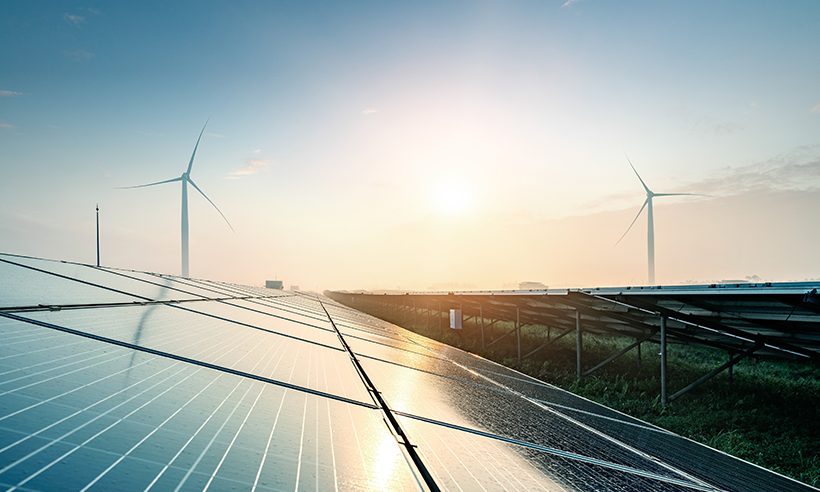 Image of solar panels and wind turbines Investing in Tomorrow: The Mid-Market Infrastructure Advantage